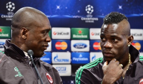 AC Milan's Dutch coach Clarence Seedorf (L) and AC Milan's forwards Mario Balotelli give a press conference, on the eve of their Champions League football match between AC Milan and Atletico Madrid , on February 18, 2014, at their training center in Milan. Seedorf expects a formidable challenge from on-form Atletico Madrid on their visit to the San Siro for the first leg of their Champions League last 16 tie. AFP PHOTO / GIUSEPPE CACACE        (Photo credit should read GIUSEPPE CACACE/AFP/Getty Images)